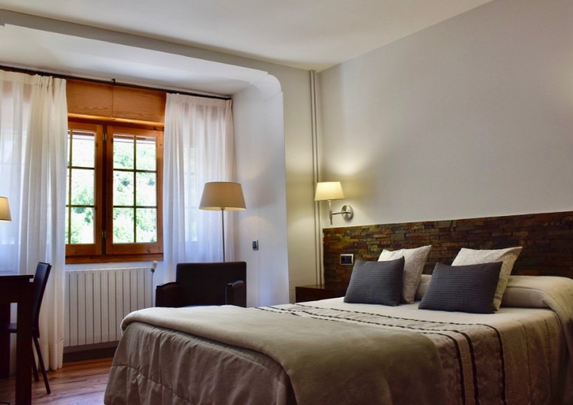 Habitació equipada con llit doble, escritori i butaques